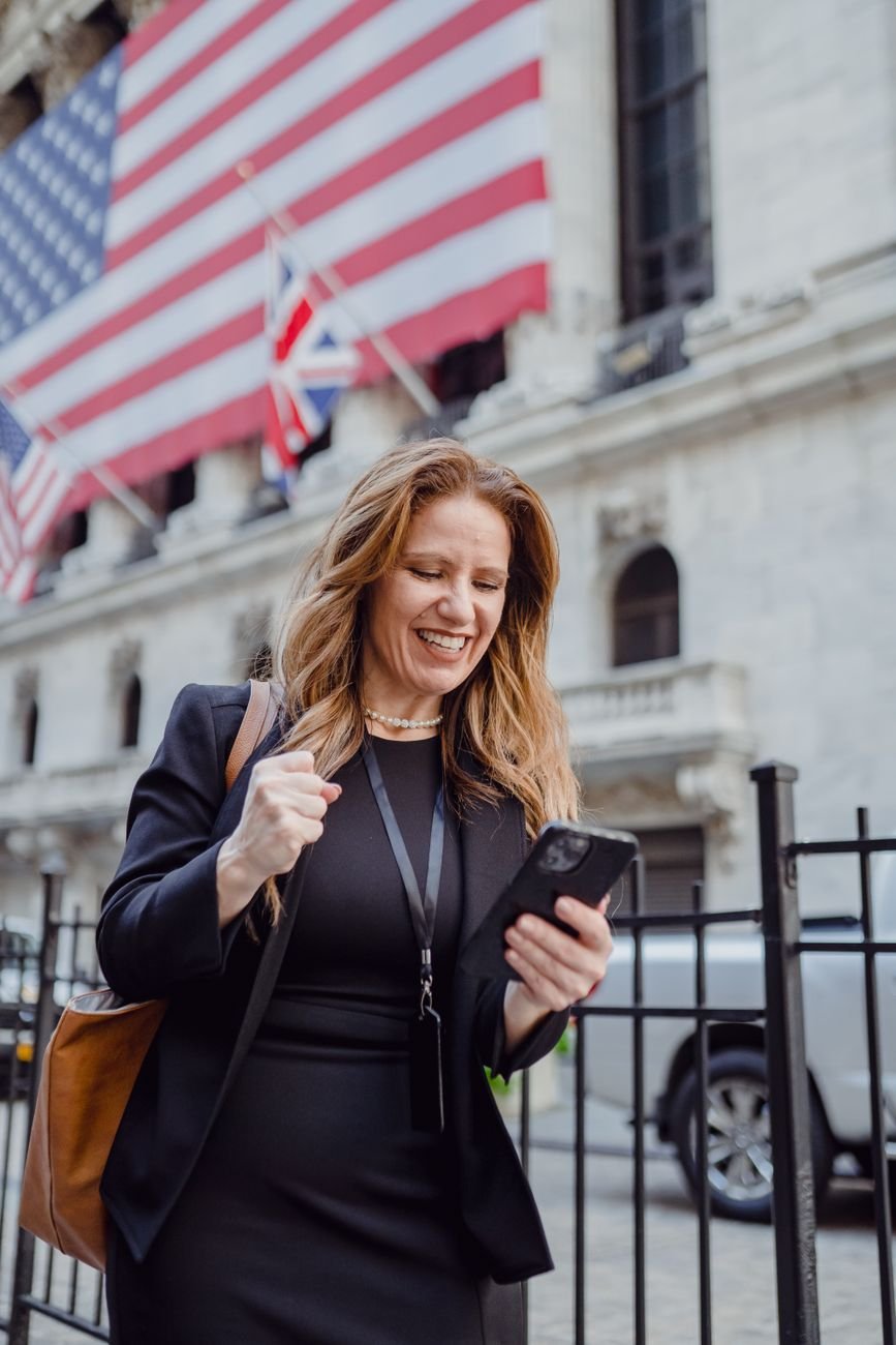 Cheerful businesswoman celebrating good news — a Vantage Advocacy client