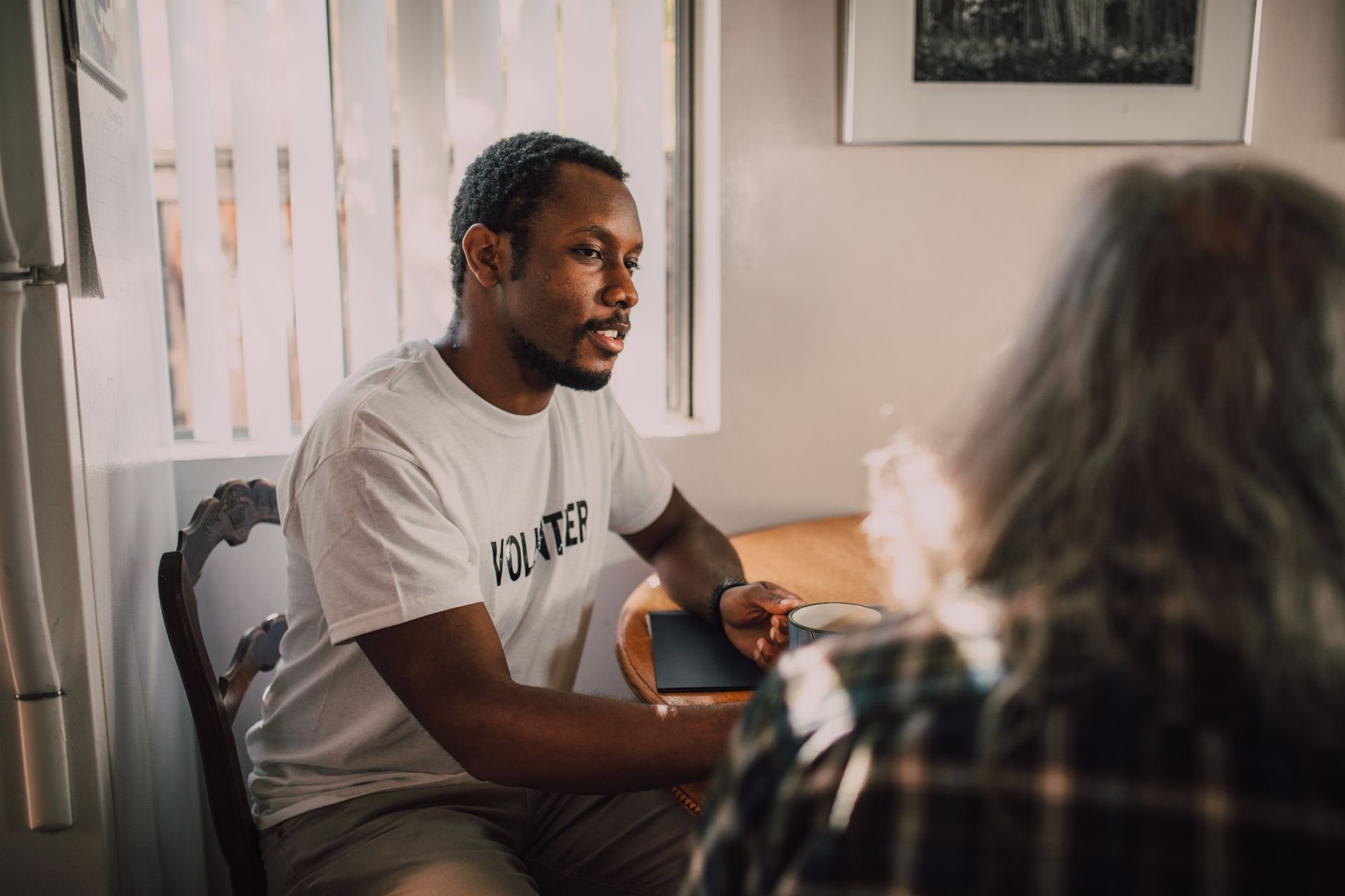 Two people having a thoughtful, warm conversation — an advocate listening carefully